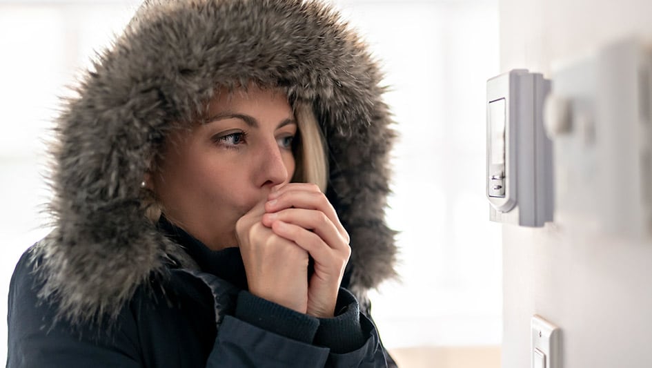 a woman wearing a hat talking on a cell phone