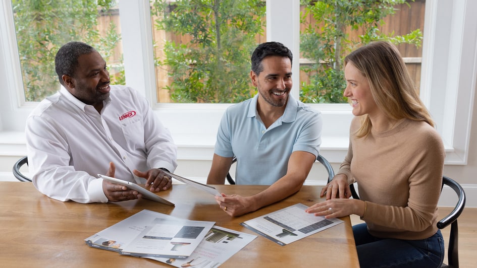 Paul Diaz et al. sitting at a table using a laptop